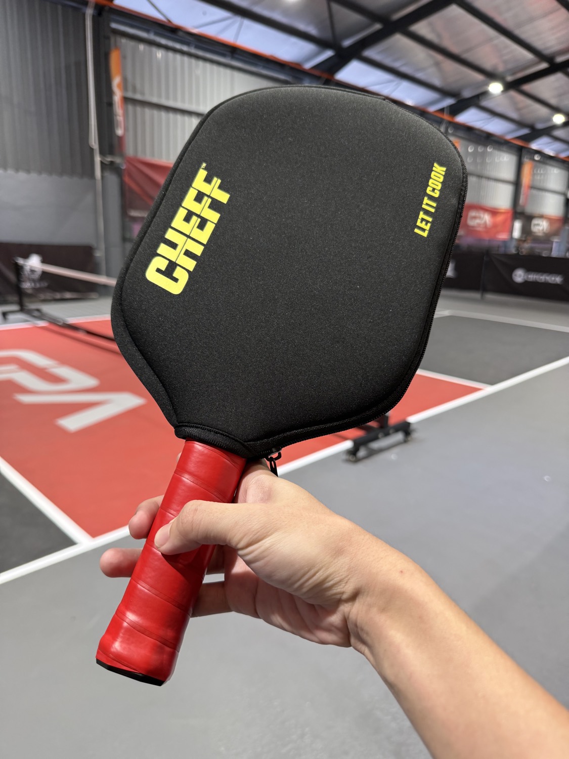 CHEFF paddle in protective sleeve on court